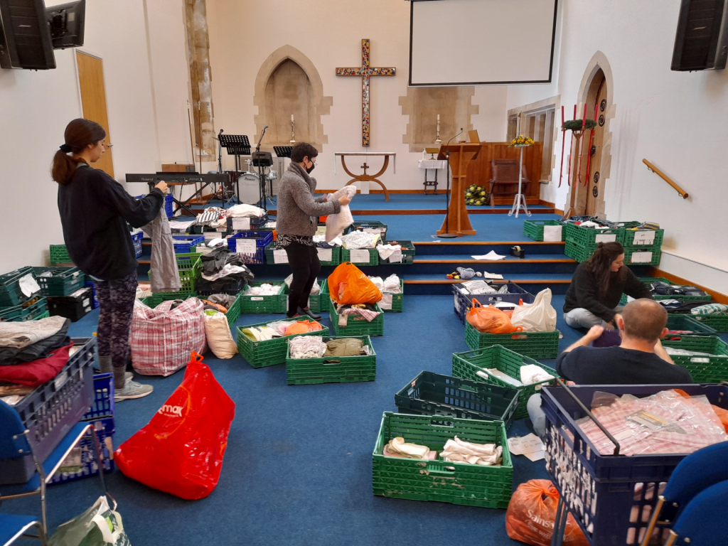 People sorting through crates of donations